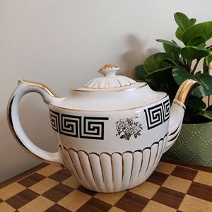 Elegant White and Gold Decorative Teapot with Black Geometric Trim
